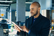 © Nana_studio - Happy african american businessman or designer or creative man with tablet in hands in modern office, business portrait