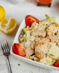 Canvas Print - close up of caesar salad with chicken lettuce tomato parmesan