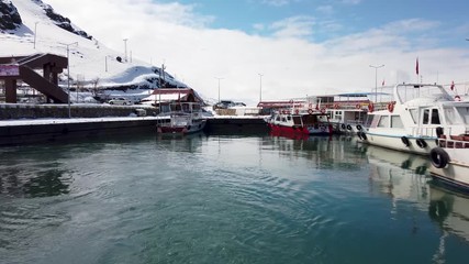 Wall Mural - Akdamar island, Van, Turkey - February 2020: Boats in harbour which are touring Akdamar island and surp church Akdamar church is an important religious place for the Armenian people