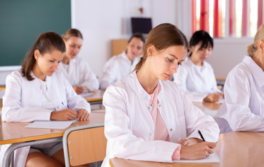 Wall Mural - Medical students writing in notepads