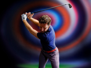 Wall Mural - Golf player in a blue shirt taking a swing, on a dark graphic background