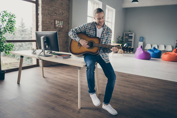 Sticker - Photo of handsome business guy have free minute while boss chief absent playing guitar lazy assistant secretary wear casual shirt sitting table modern office indoors