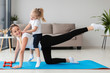 © FreepikCompany - Smiling mother exercising at home with daughter