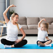 © FreepikCompany - Front view of happy mother exercising with daughter at home