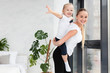 © FreepikCompany - Side view of mother posing with daughter at home while working out