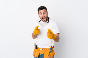 Wall Mural - Craftsmen or electrician man over isolated white background points finger at you