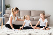 © FreepikCompany - Front view of mother and daughters at home exercising