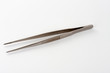 Medical surgical dressing tweezer on white background, tool used in wound treatment in ICU