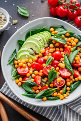 Wall Mural - Fresh healthy salad with chickpea, avocado, cherry tomatoes and spinach.