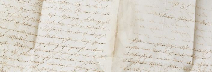 closeup of old handwriting; vintage paper background