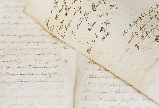 closeup of old handwriting; vintage paper background
