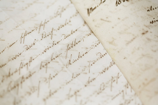 closeup of old handwriting; vintage paper background