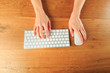 © Fototocam - Female hands working with modern white keyboard and mouse on wooden background, top view  - Image