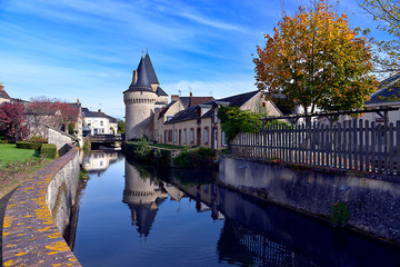 Wall Mural - Keep of the fortified gate Saint-Julien on the Huisne river with big reflection at La-Ferté-Bernard, a commune in the Sarthe department in the Pays de la 	Loire region in north-western France.