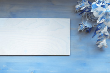 Canvas Print - Blue frame on wooden background with flowers in blue color toned, copy space, text place. Classic blue Color of 2020 year.