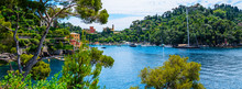 Scenic picture-postcard view of famous with wonderful gulf, luxury villas in mediterranean garden, rock and boats, yachts in spectacular vacation resort, Portofino, Liguria, Italy, Europe.