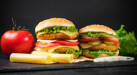 two hamburgers on a black background