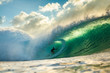 © Sacha Specker - surfer riding a big barrelling wave at pipeline Hawaii