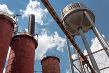 Sloss Furnaces National Historic Landmark, Birmingham Alabama USA, View Looking Up At Water Tower And Furnaces Against A Blue Sky With Clouds, Horizontal Aspect