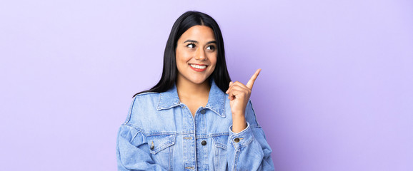 Wall Mural - Young latin woman woman over isolated background pointing up a great idea