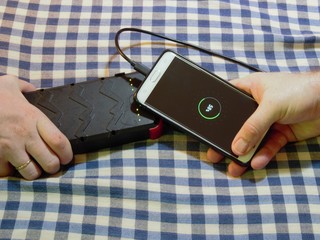 charging cell mobile phone with someone esles power bank and cable