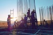 © Ratta Lapnan - The construction of a rooftop high rise building, workers are tied with steel bars for concrete pouring, surveying the site and cranes are lifting or moving metal at the construction site. Pastel tone