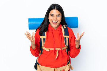 Wall Mural - Young Colombian mountaineer girl with a big backpack isolated on white background unhappy and frustrated with something