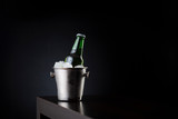Fototapeta Panele - Bottle of beer in an ice bucket