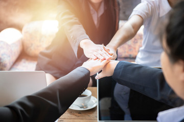 Business people group put hands together in stack pile at training as concept of sales team corporate unity connection, team-building loyalty, support in teamwork, coaching, close up top view