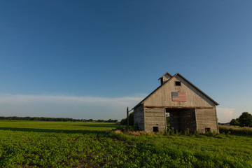 Old wooden barn with american flag.