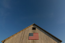 Old Wooden Barn With American Flag.