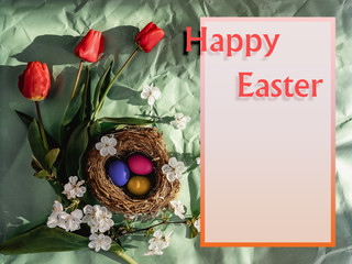 Easter card. Multi-colored Easter eggs in a nest, red tulips, a branch with white flowers and the inscription Happy Easter.