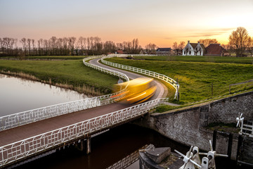 Wall Mural - Curve light trails on country road in the landscape of the province of Groningen, The Netherlands