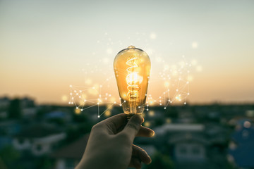hand business man holding light bulb with light line. alternative energy, idea, saving electricity i