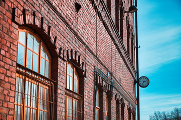 old brick building with windows and an old clock .