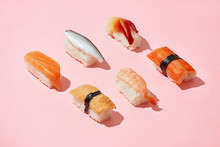 Sushi Set Of Different Nigiri Idea, Creative Top On A Pink Background Isolated