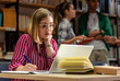 © Zoran Zeremski - Young female student study in the library using laptop for researching online.