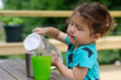 © Lauren Naefe/Stocksy - Little kid pouring water