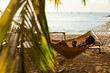 © Mauro Grigollo Photographer/Stocksy - Woman relaxing on the hammock on the beach at sunset