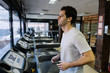 © Luis Velasco/Stocksy - Young Man Running On Treadmill In Gym.