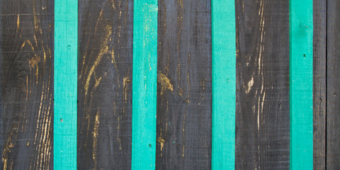 Striped unpolished wooden surface black background gray and green stripes wood texture