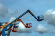 © Alex Lyubar - Rental construction  equipment. Boom lifts  with raised platforms are on-site on   for the equipment for rent