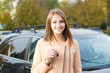 © hbrh - appy, smiling, young attractive woman, buyer near her new car showing keys