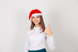 © hbrh - girl wearing red Santa hat giving thumbs up, excited about upcoming holidays on white