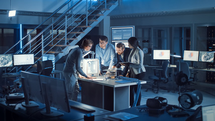 Leinwandbilder - Diverse Team of Electronics Development Engineers Standing at the Desk with 3D Printer and PCB Motherboards. Specialists Collectively Working on Modern Industrial Design, Using Latest Tablet Devices