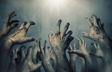 Zombie hands rising in dark Halloween night.