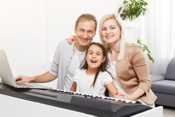 Canvas Print - family plays the digital piano at home, learning online, family rest during quarantine, self-isolation, online education concept. support for loved ones concept