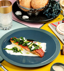 Poster - roasted salmon fillet served on cream sauce with spinach on top