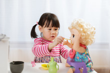Toddler Girl Pretend Play Feeding Baby  At Home