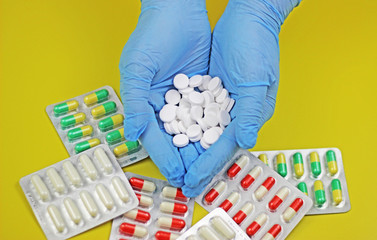 Wall Mural - a pile of white pill tablet medicine or supplement in women hands